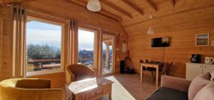 a living room with a large window in a cabin at Podbucznik 4 Polica in Targoszów