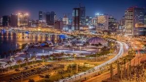 a city skyline at night with a busy street at A vista perfeita in Luanda