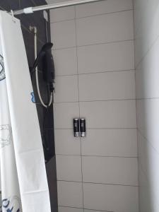 a shower stall with a phone in a bathroom at Happy Family Horizon Suite - near Xiamen-KLIA Netflix in Kampong Melot