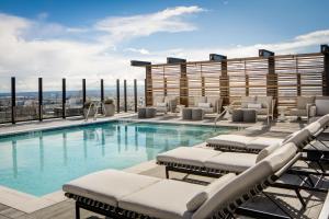 a swimming pool with lounge chairs and a building at Element Salt Lake City Downtown in Salt Lake City