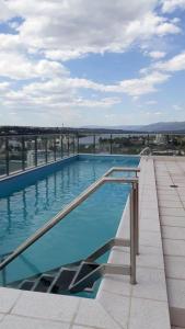 a swimming pool on the roof of a building at Edificio Leonardo Apart Centro in Villa Carlos Paz