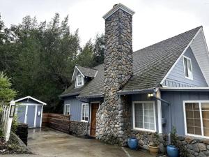 a blue house with a stone chimney on it at Tranquil retreat in Los Gatos in Los Gatos