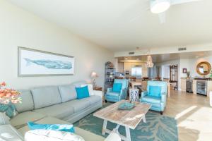 a living room with a couch and chairs and a table at Caribe D814 in Orange Beach +66 photos