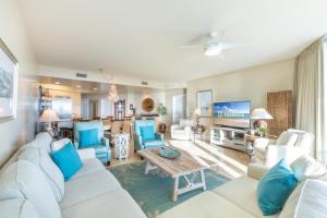 a living room with a white couch and a table at Caribe D814 in Orange Beach