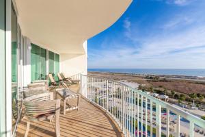 a balcony with chairs and a view of the ocean at Caribe D814 in Orange Beach