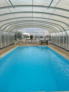 a large swimming pool in a building with blue water at LUZ E SAL by Stay in Alentejo in Cavaleiro