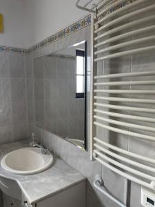 a bathroom with a sink and a mirror at LUZ E SAL by Stay in Alentejo in Cavaleiro