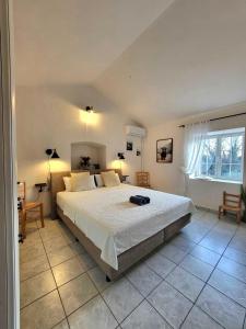 a bedroom with a large bed and a large window at Qća Krk Apartments in Dobrinj