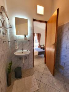 a bathroom with a sink and a mirror at Qća Krk Apartments in Dobrinj +39 photos