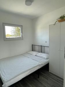 a bedroom with two beds and a window at Osada Chłopy in Chłopy