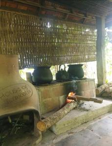 a brick oven with pots on top of it at Sang Natha Lodge in Tjatur
