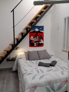 a bedroom with a bed and a staircase at Christian in Cruce de Arinaga