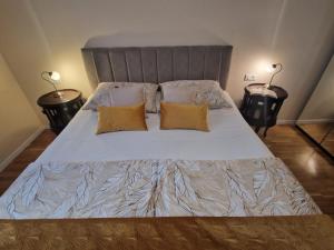 a large bed with two pillows on top of it at La-La Rooms in Zadar