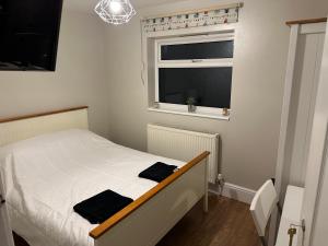 a small bedroom with a bed and a window at Sweet street in Barton in the Clay