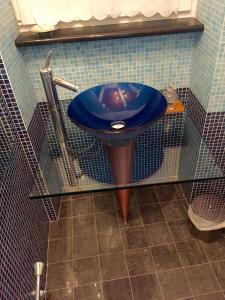 lavabo azul en la esquina de un baño en Monticello, en Valdengo