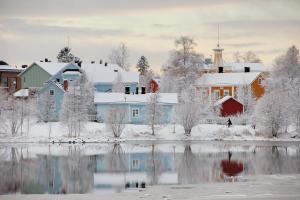 a town with snow covered buildings and a lake at Kaarteen yksiö in Oulu