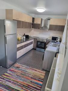 a kitchen with a white refrigerator and a rug at Charming two- bedroom house in Bucharest