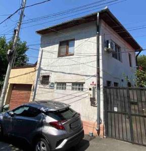 a car parked in front of a house at Charming two- bedroom house in Bucharest