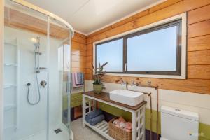 a bathroom with a sink and a window at Comfort and Style in this Petone Townhouse in Lower Hutt