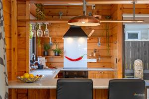 a kitchen with a painting of a chili pepper at Comfort and Style in this Petone Townhouse in Lower Hutt