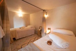 a room with two beds in a room at Ecolodge Atlas Kasbah in Agadir