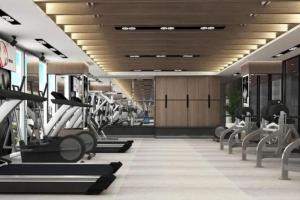a gym with treadmills and machines in a building at Delft Apartment - Sea View Studio Flat at Losari Beach in Makassar