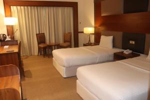 Voodi või voodid majutusasutuse GSS Avenue Hotel Ex Delmon Hotel toas