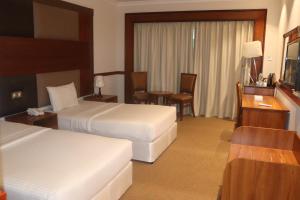 Voodi või voodid majutusasutuse GSS Avenue Hotel Ex Delmon Hotel toas