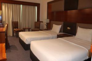 Voodi või voodid majutusasutuse GSS Avenue Hotel Ex Delmon Hotel toas
