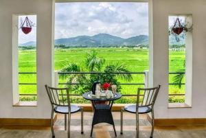 a dining room with a table and chairs and a window at Corbett Wild Nature View Resort in Rāmnagar