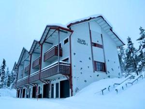 un edificio en la nieve con árboles en el fondo en Holiday Home Ylläs Villas, en Ylläsjärvi