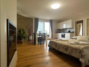 a bedroom with a bed and a kitchen and a table at Podere Belsogno-Miniappartamento Roseto in Montalcino