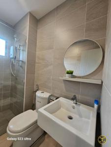 a bathroom with a sink and a toilet and a mirror at Sunway Ipoh - DamaiStay - 5min to Tambun - 20Pax in Tambun