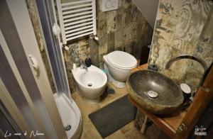 a bathroom with a sink and a toilet and a sink at La Casa di Nonna in Tivoli