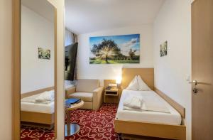 מיטה או מיטות בחדר ב-Vital-Hotel-Styria