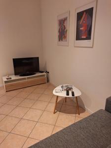 a living room with a tv and a coffee table at Mi'Ele Apartments in Pergine Valsugana