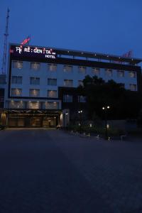 a building with a sign on the top of it at Regenta Inn Morbi in Morbi