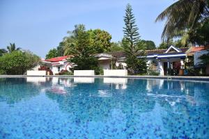 a swimming pool in front of a house at You are the key Villa in Anjuna