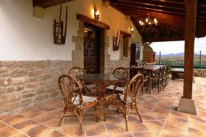 a dining room with tables and chairs on a patio at CASA URRA 