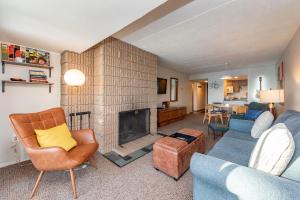 a living room with a fireplace and a couch and chairs at 208B One Bedroom One Bath in Oakland