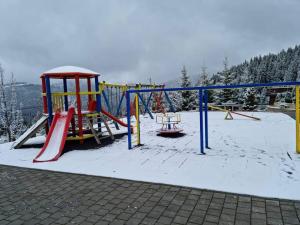 a playground in the snow with a slide at Eko FIS Snowscape in Šišava