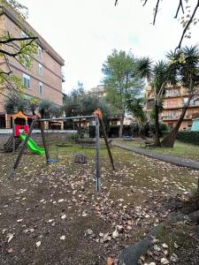 a playground with a swing set in a park at AmoRoma Holiday in Rome