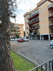 a parking lot with cars parked in front of a building at AmoRoma Holiday in Rome