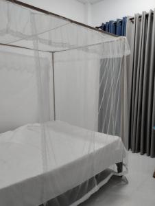 a bed with a canopy in a room with radiator at Dream Villa in Matara