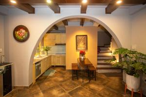 an archway in a kitchen with a table and chairs at Chez Van in Hanoi