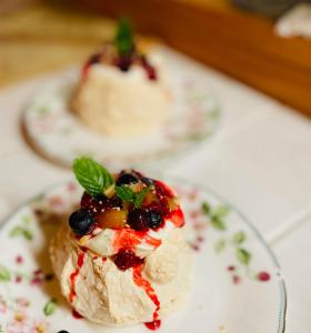 a dessert on a plate with berries and whipped cream at 1組限定ドッグフレンドリー&イギリス料理 Laughing dogs villa in Takashima