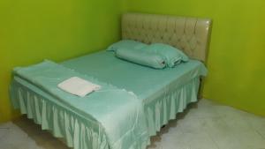 A bed or beds in a room at Bumi Abah Homestay