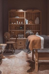 a bedroom with a bed and a wooden cabinet at La Voie Lactée in La Mongie