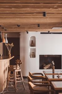 ラ・モンジーにあるLa Voie Lactéeの木製のテーブルと椅子、暖炉のあるレストラン