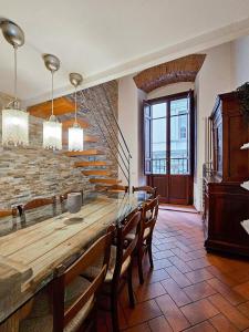 uma sala de jantar com uma grande mesa de madeira e cadeiras em Confortevole App Centro Storico em Florença